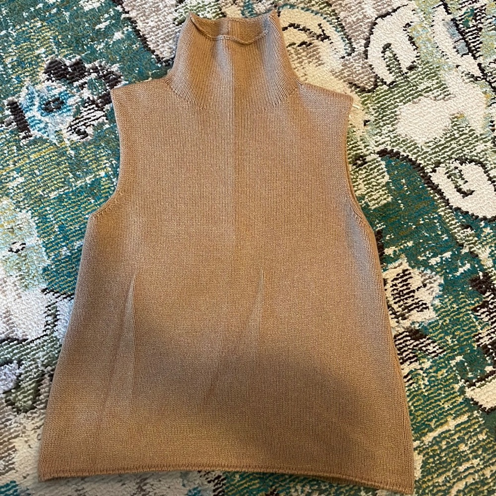 The Row camel sleeveless cashmere turtleneck.